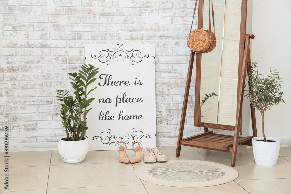 Stylish interior of room with green houseplants and mirror