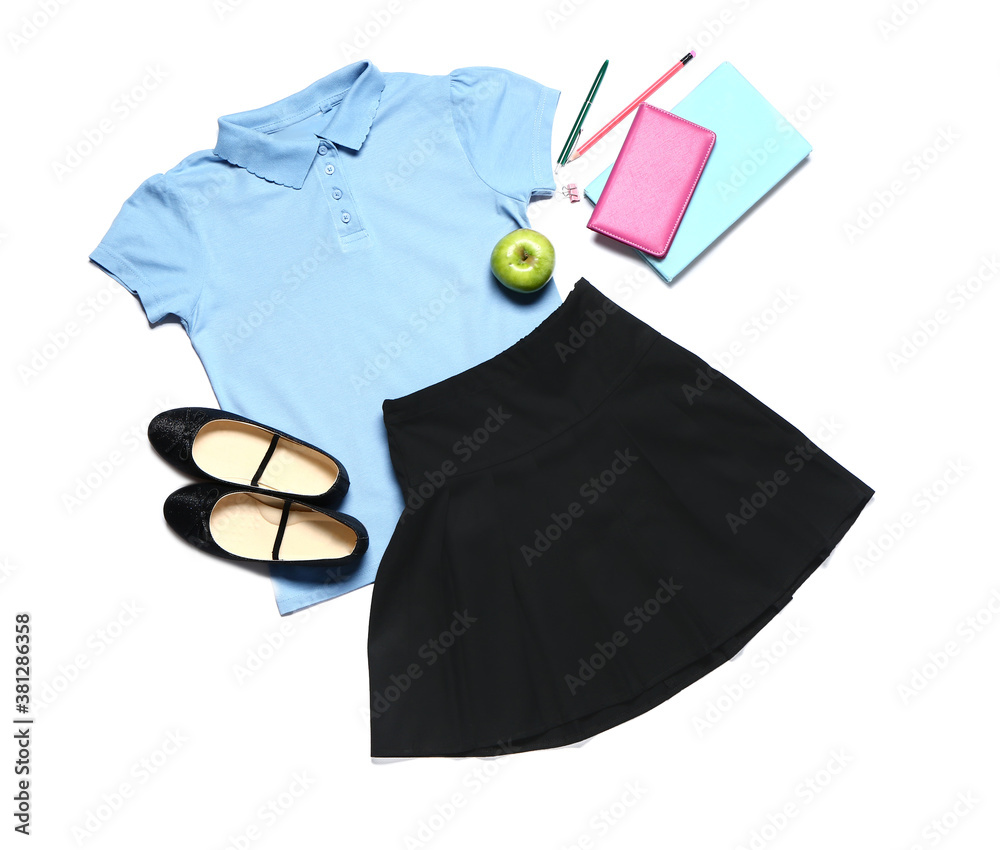 Stylish school uniform with stationery on white background