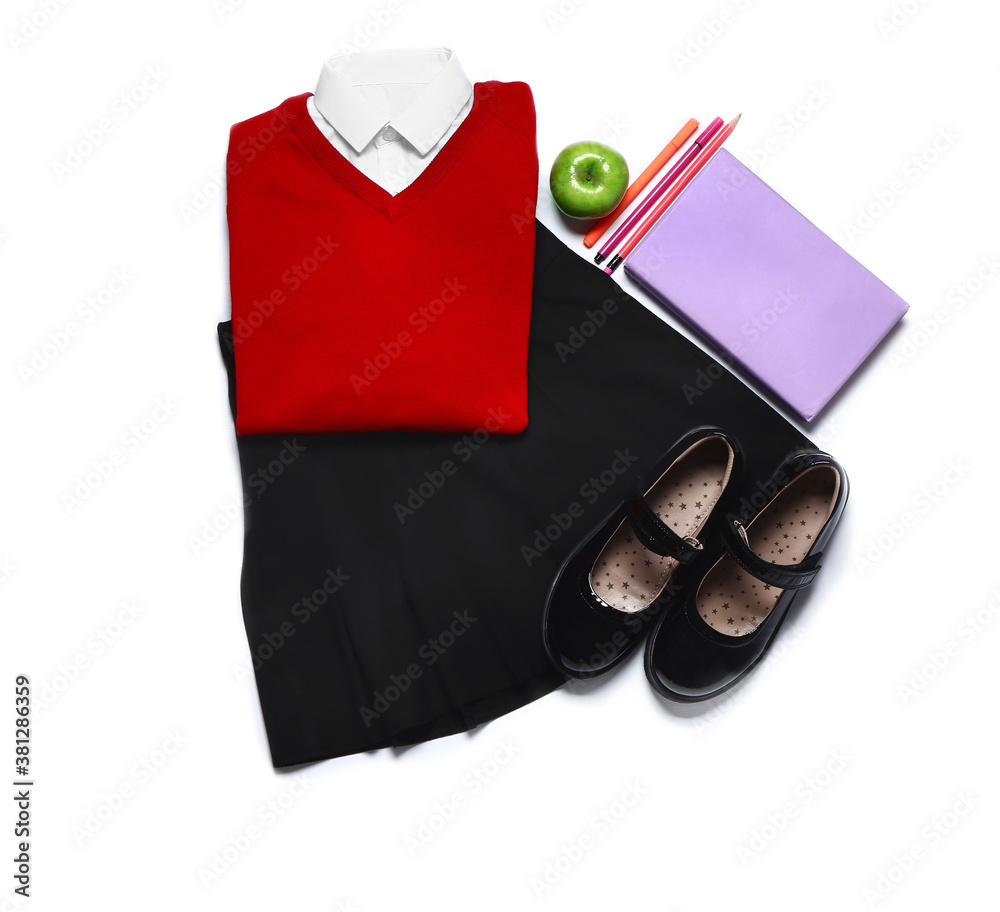 Stylish school uniform with stationery on white background