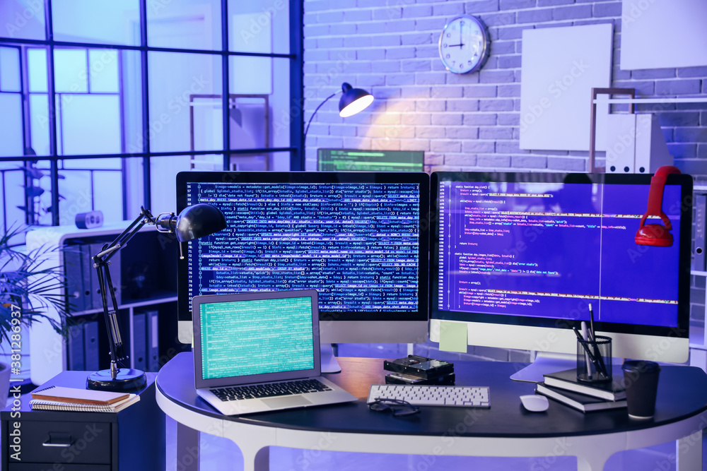 Workplace of programmer in office at night