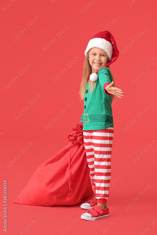 Cute little girl dressed as elf and with Santa Claus bag on color background