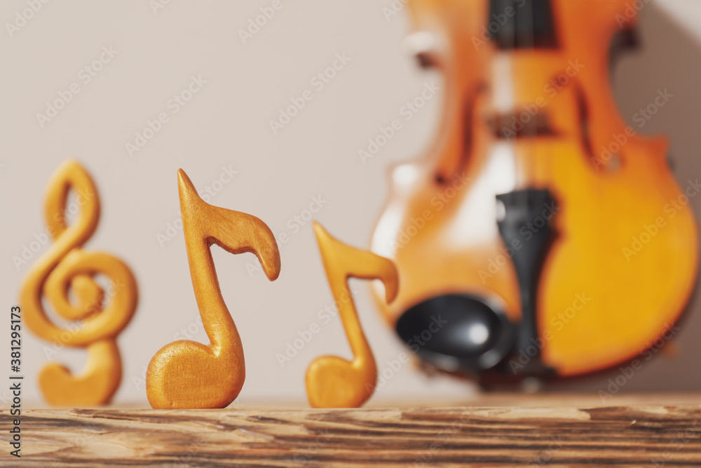 Music notes on wooden table, closeup