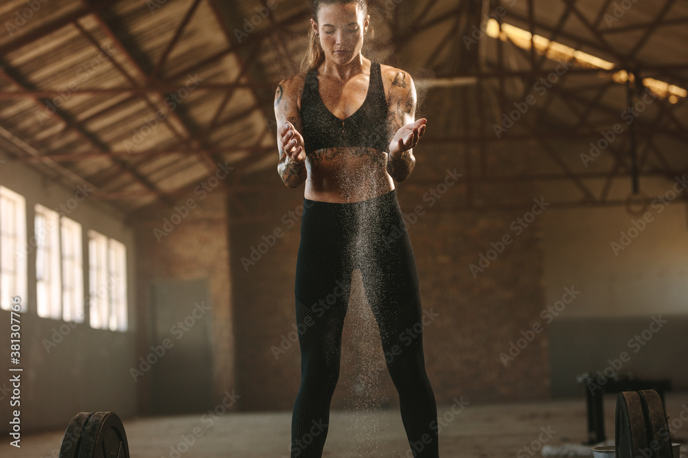 Strong woman preparing for weightlifting workout