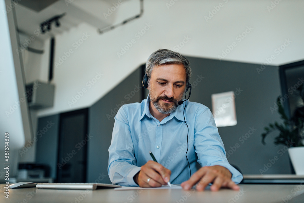 Writing an letter to his company.