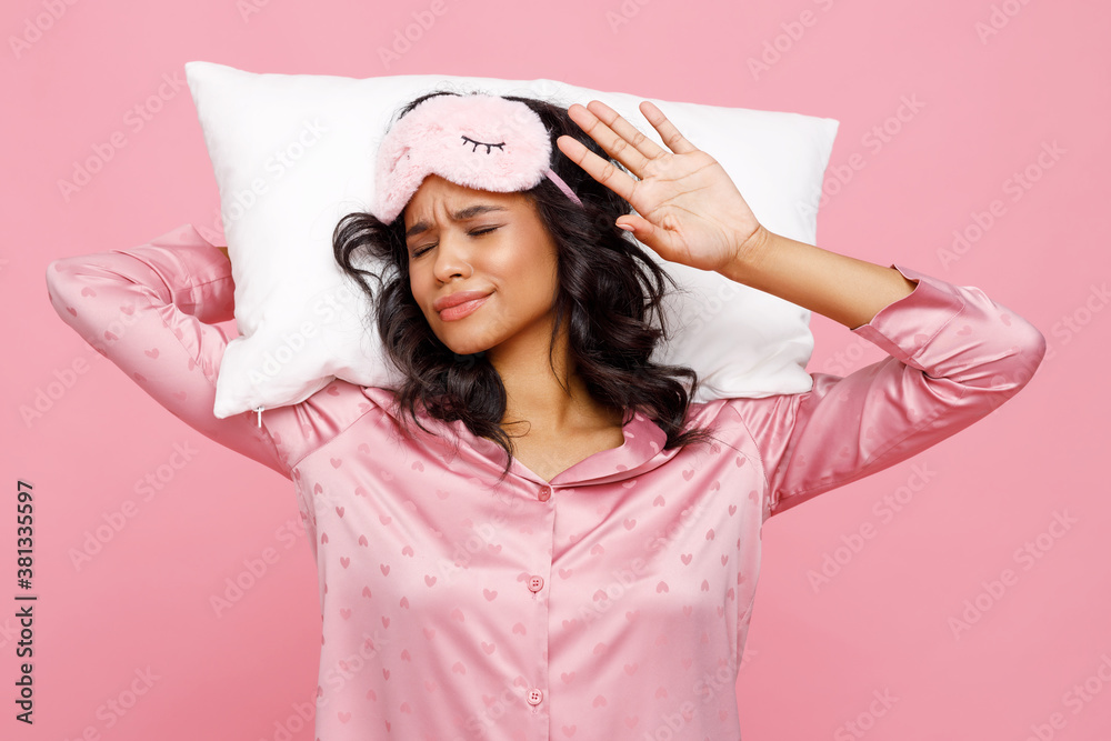 Sleepy ethnic female with pillow