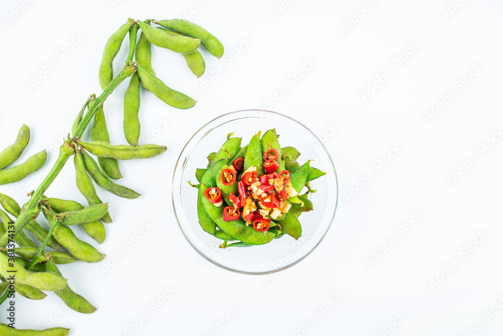 A plate of delicious cold edamame on white background