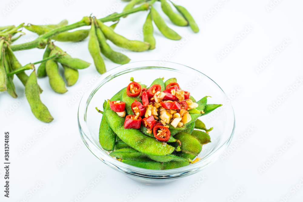 A plate of delicious cold edamame on white background