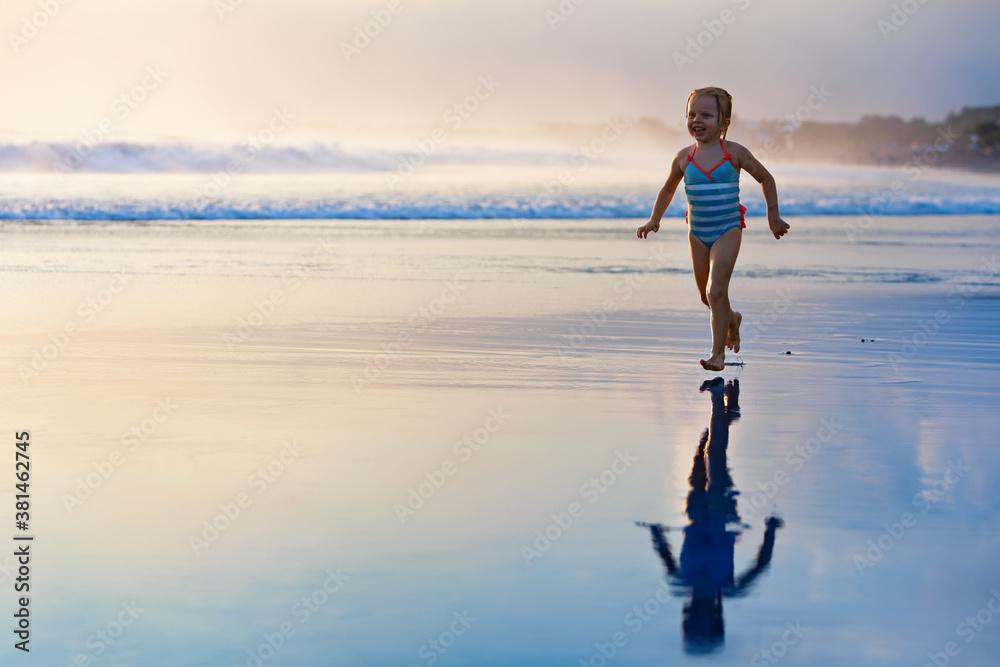 Happy family have fun on tropical sea beach resort. Funny baby girl run with splashes by water pool 