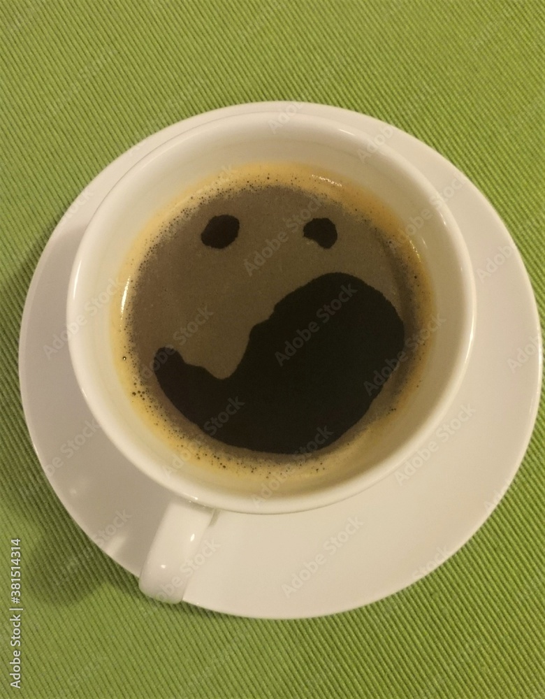 a cup of coffee on a green background