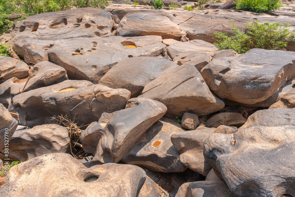 Stone courtyard in nature with bumpy, small and large. erosion by the currents, gravel swirled and e