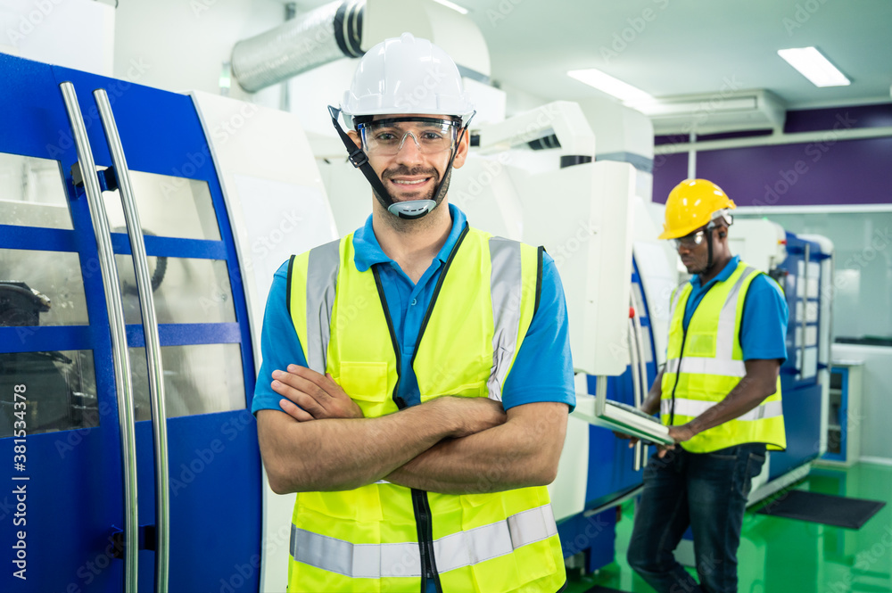 Caucasian Engineer man standing, crossed arms and wearing safety wears