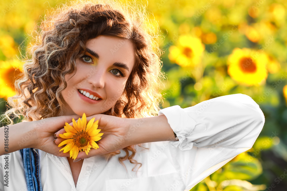 Beautiful young woman in sunflower field