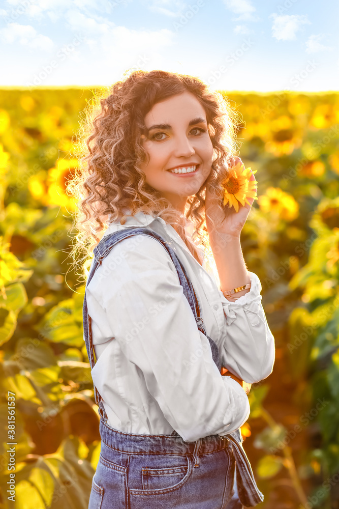 Beautiful young woman in sunflower field