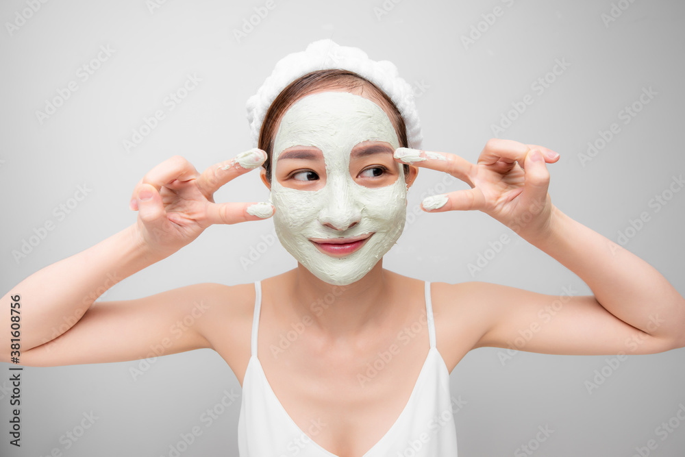 Young beautiful woman in face mask of therapeutic blue mud. Spa treatment, self care and healthy ski