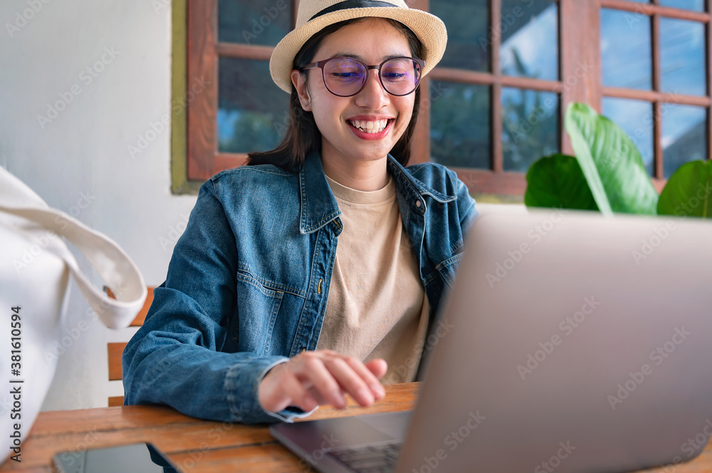 young woman working on laptop in coffee shop