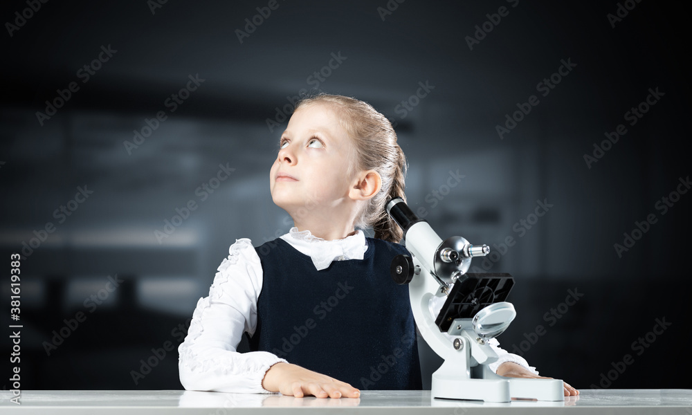 Little girl scientist with microscope