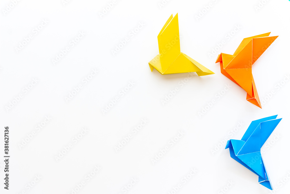 Origami concept. Paper birds top view, copy space