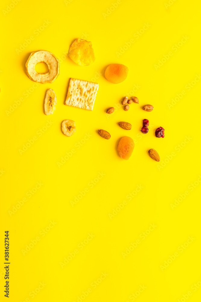 Healthy snacks overhead - nuts and dried fruits with crackers