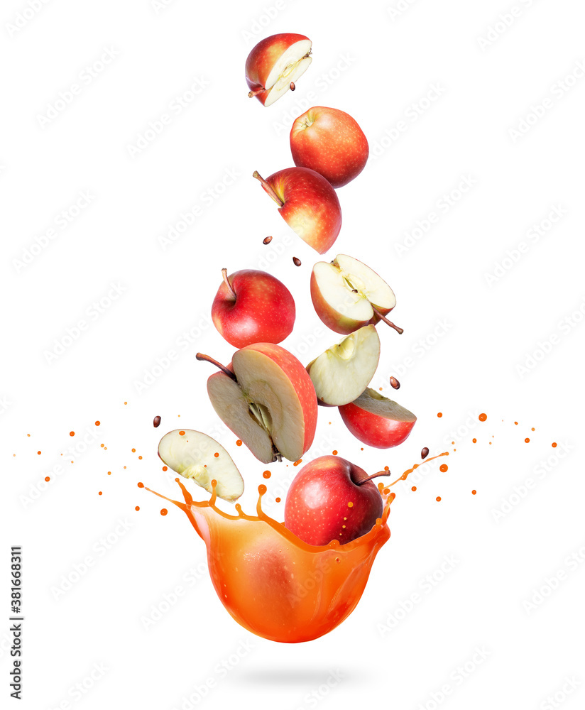 Whole and chopped ripe apples are falling in splashes of juice on a white background