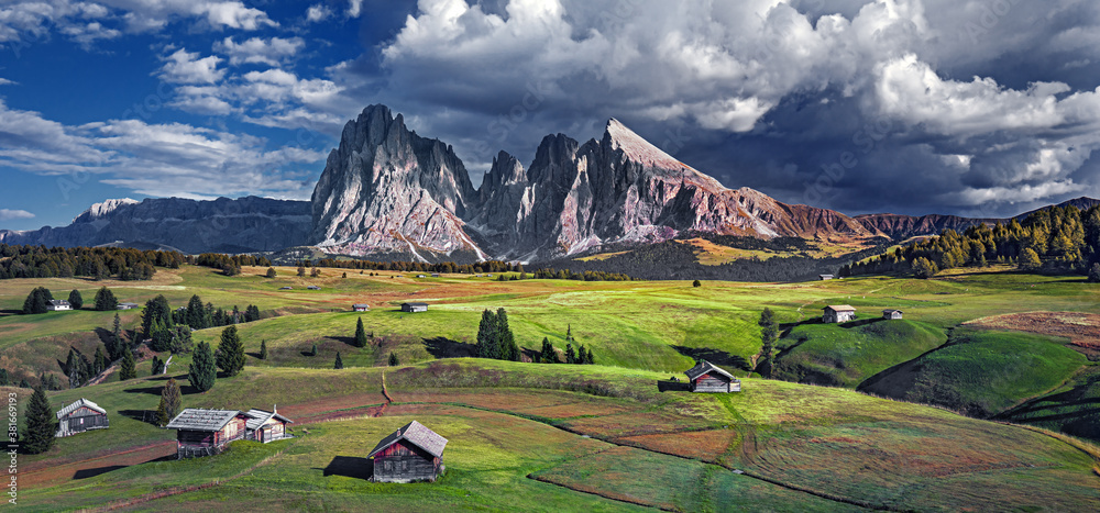 Famous Alpe di Siusi - Seiser Alm with Sassolungo - Langkofel mountain group in background at sunset