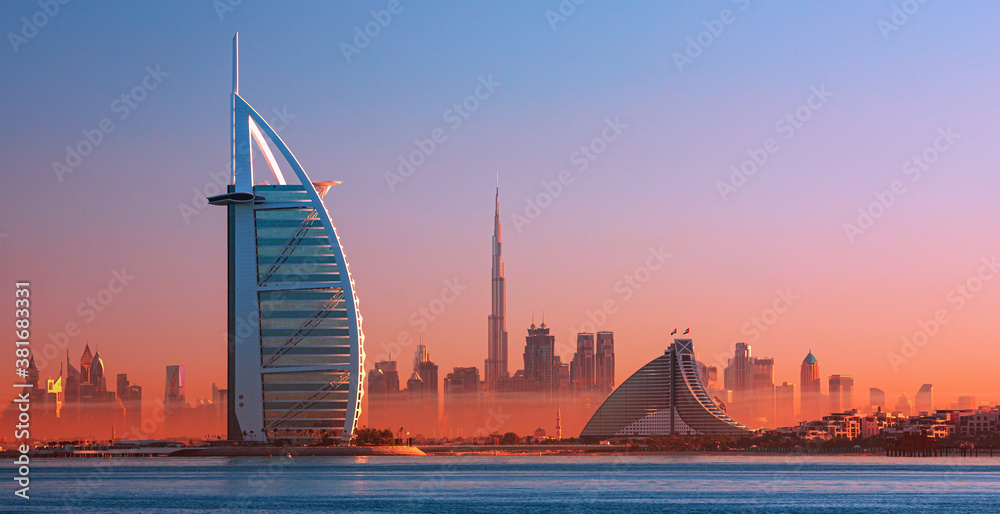 Dubai city - amazing city center skyline and famous Jumeirah beach at sunset, United Arab Emirates
