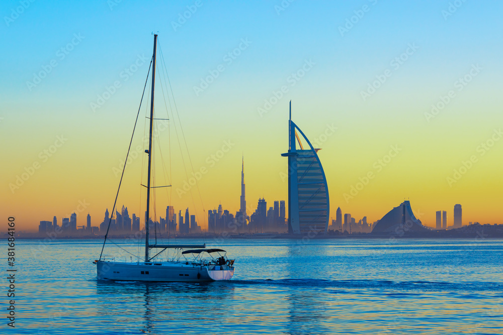 Dubai city - amazing city center skyline and famous Jumeirah beach at sunset, United Arab Emirates
