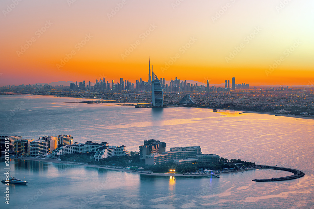 Dubai city - amazing city center skyline and famous Jumeirah beach at sunset, United Arab Emirates