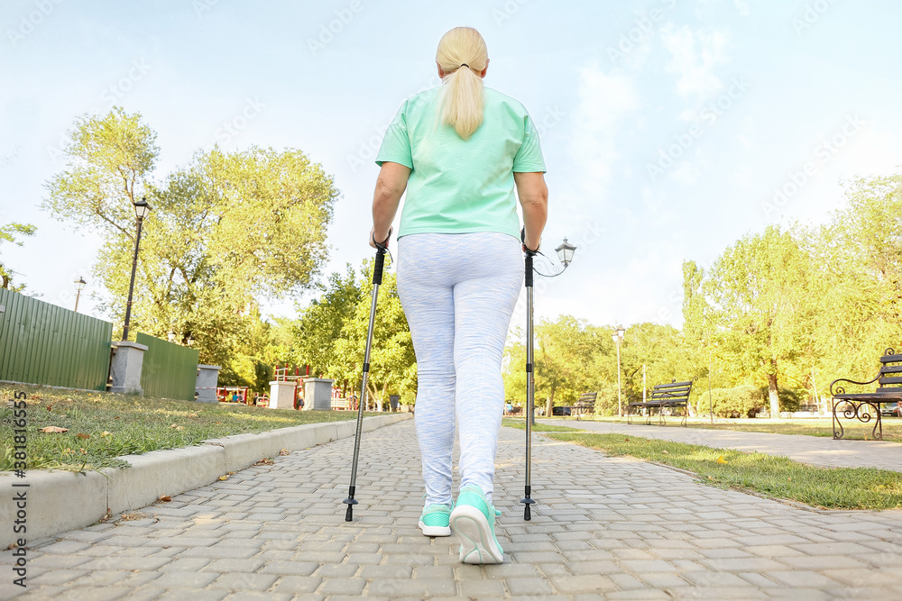 Mature woman with walking poles outdoors