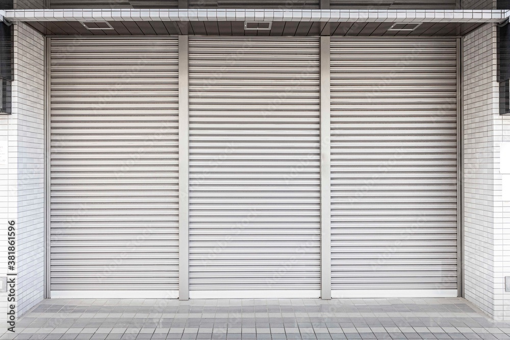 Automatic white roller shutter doors on the ground floor of the house