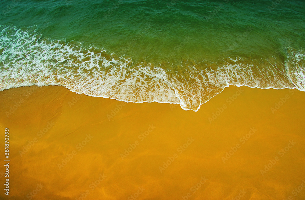 Wave of blue ocean on  beach.