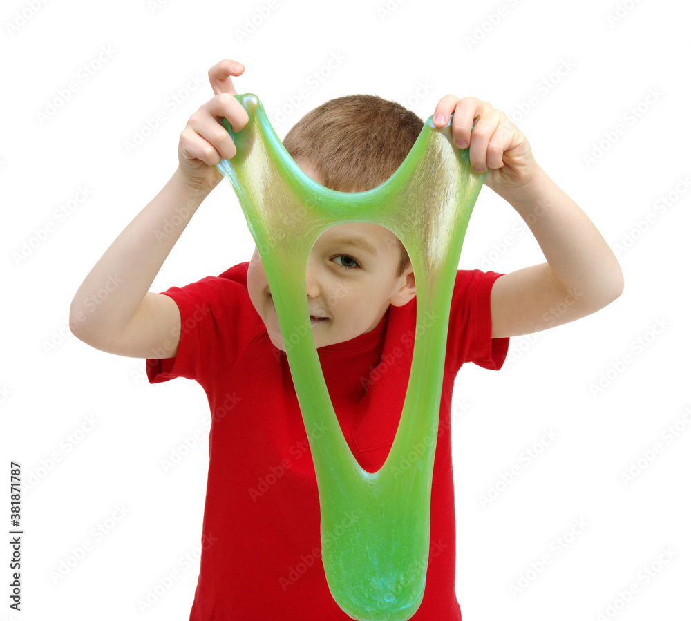 Boy stretches slime toy in hands and looks