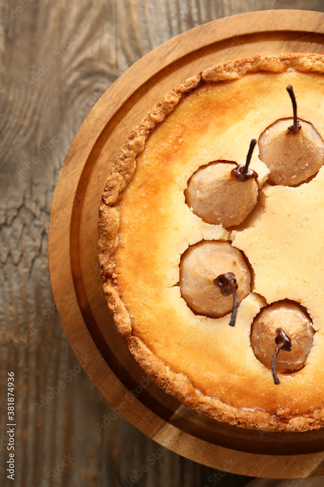 Stand with tasty pear cake on table