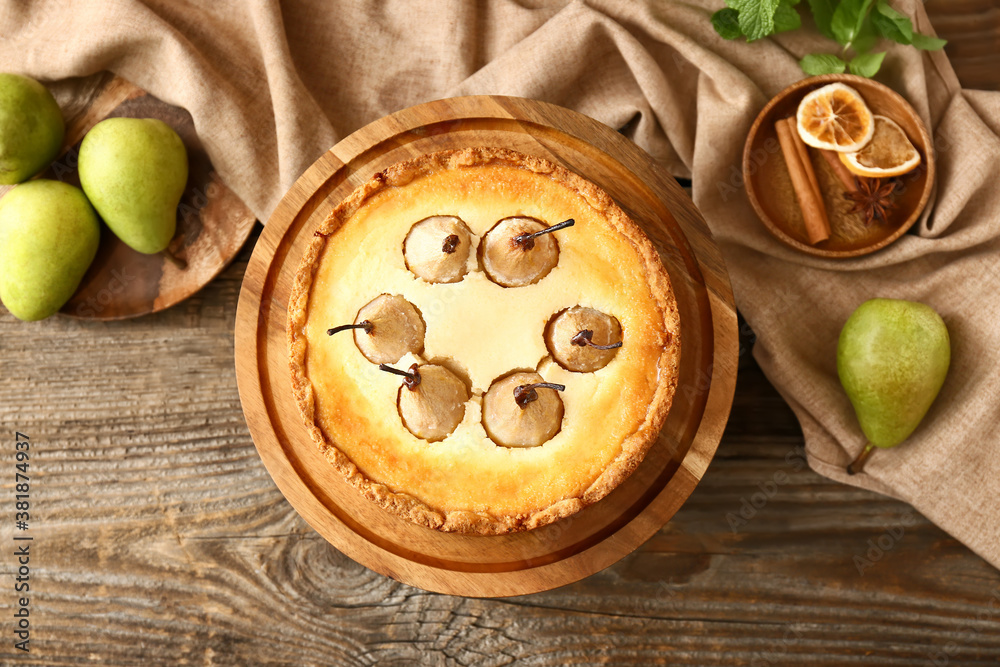 Stand with tasty pear cake on table