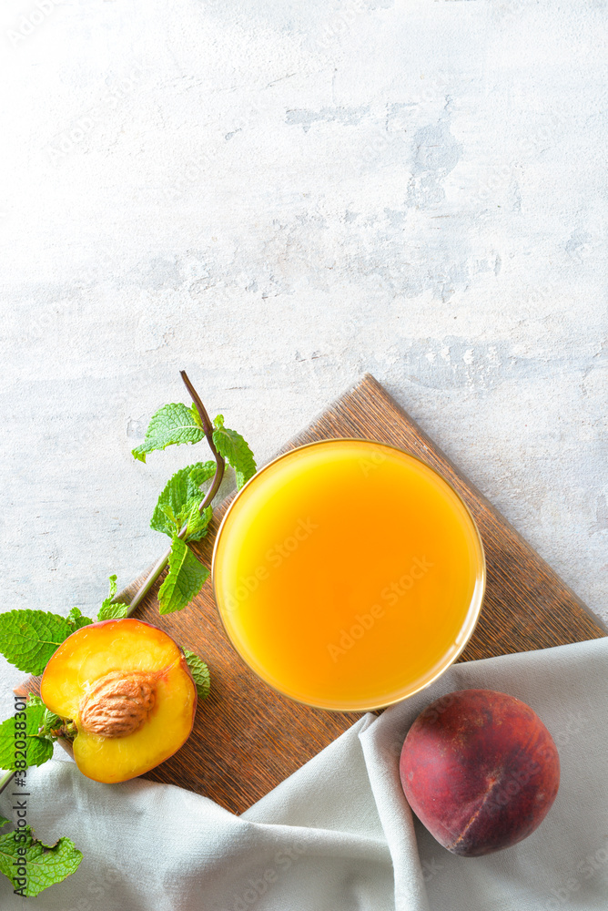 Composition with fresh peach juice on table