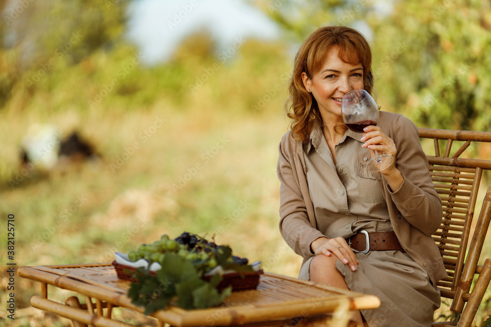 Enjoying with friends in nature, holding a glass of wine.