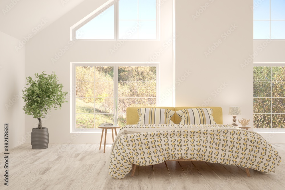 White stylish minimalist bedroom with armchair and autumn landscape in window. Scandinavian interior