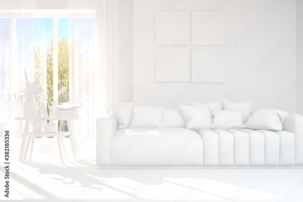 Stylish room in white color with sofa and autumn landscape in window. Scandinavian interior design. 