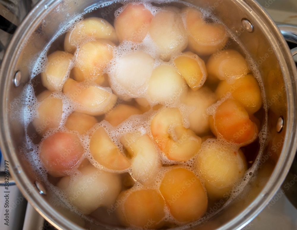 peeled boiled apples in a sugar syrup