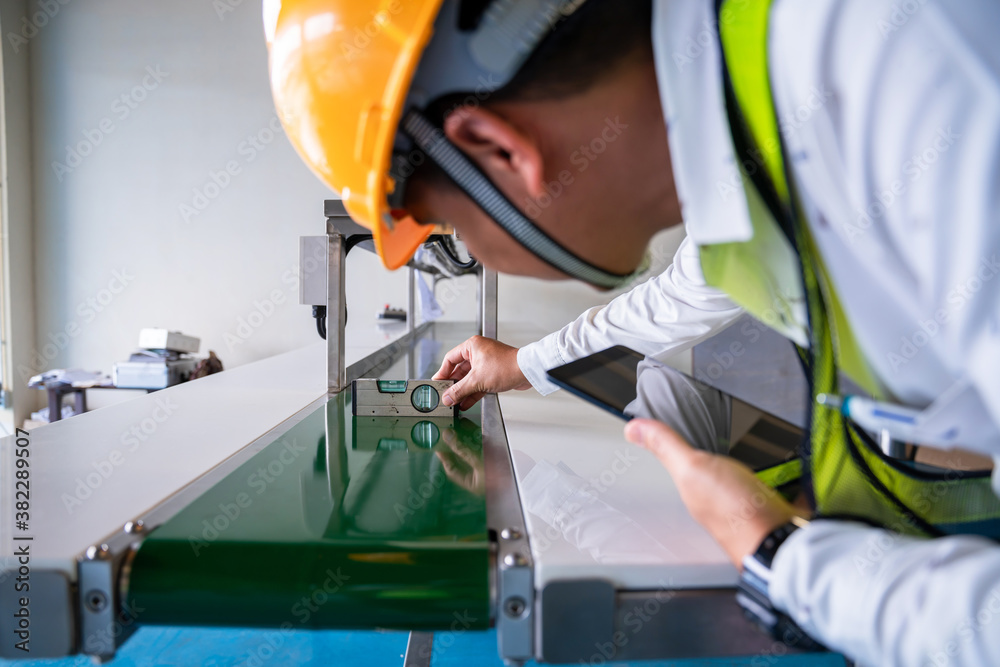 Asian man Mechanic technician worker use a water level meter working and Assemble the product sortin