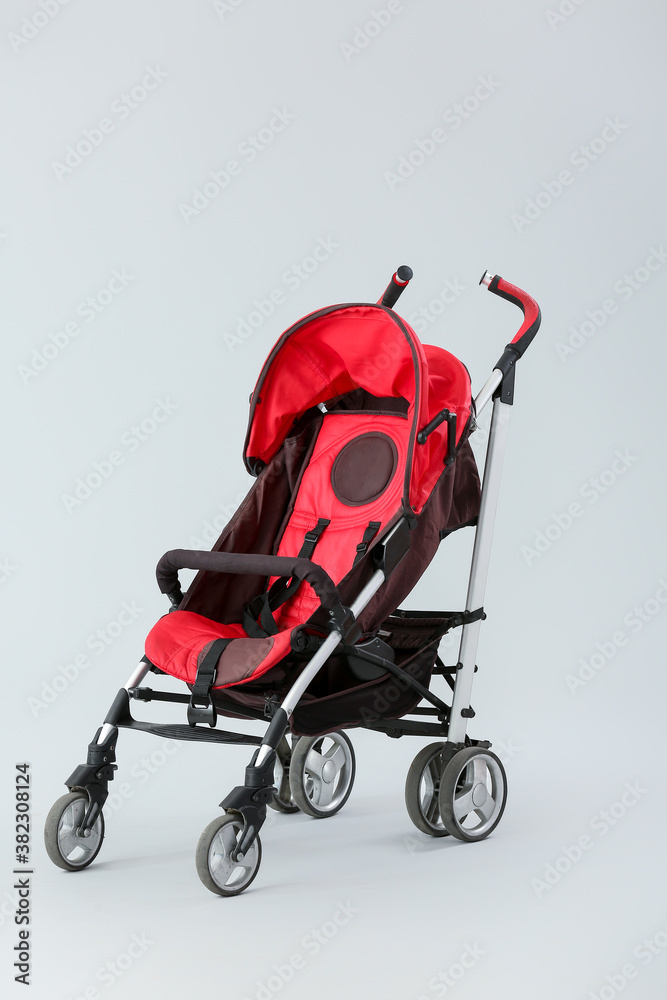 Modern baby stroller on light background