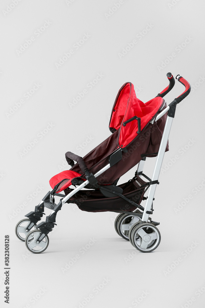 Modern baby stroller on light background