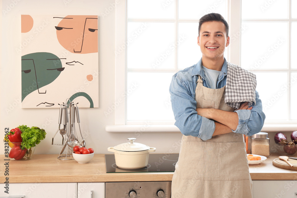 Portrait of handsome young man in kitchen