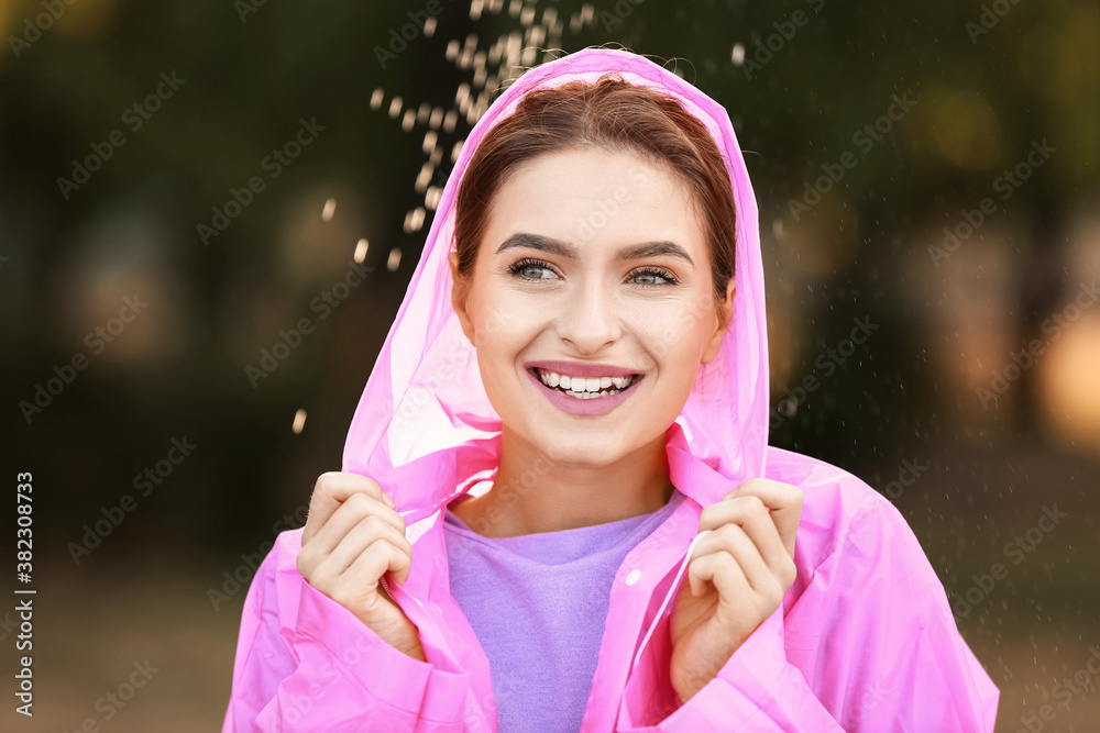 美丽的年轻女子在户外穿着雨衣