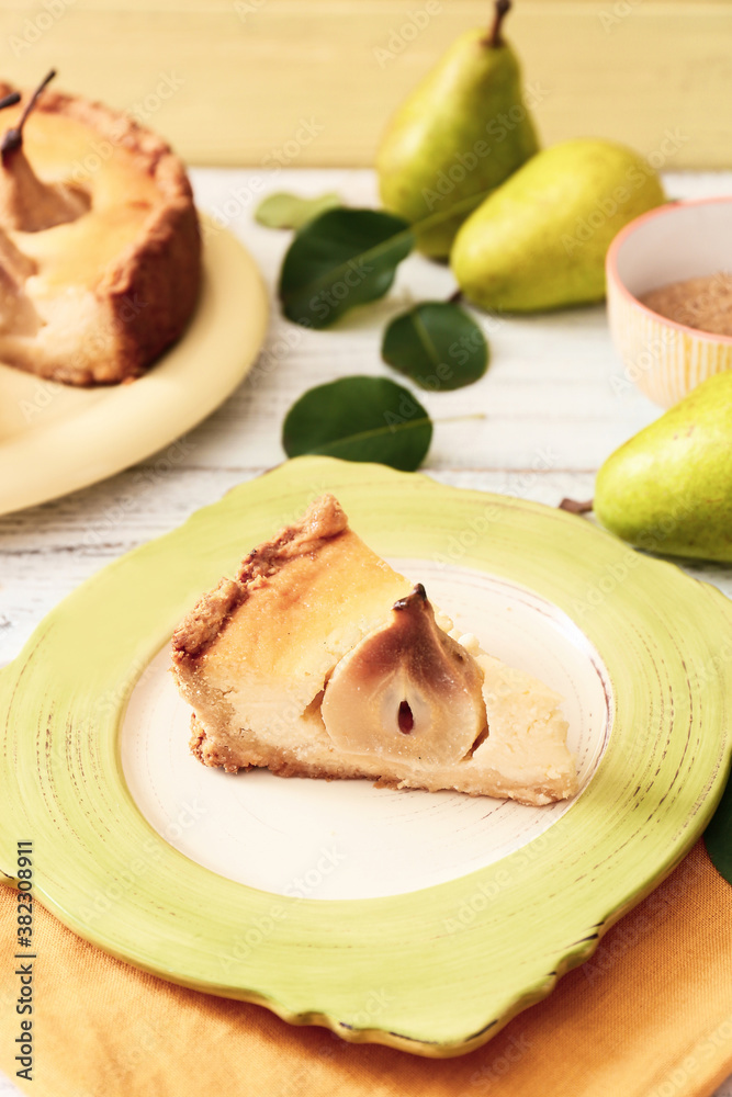 Plate with tasty pear cake on table