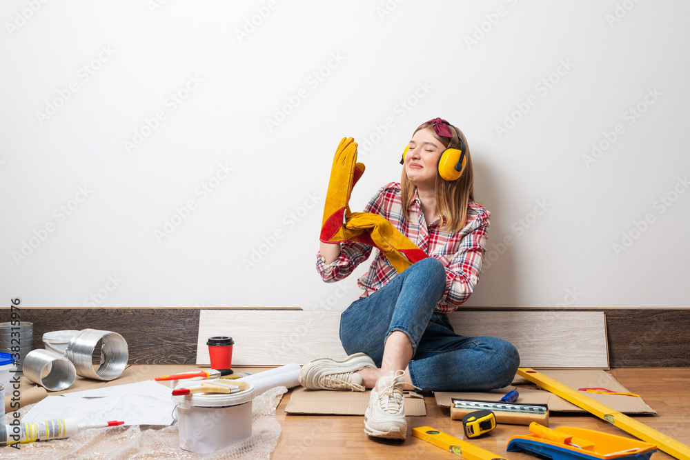 Happy girl in protective headphones and gloves