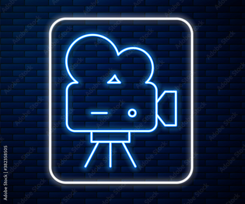 Glowing neon line Retro cinema camera icon isolated on brick wall background. Video camera. Movie si