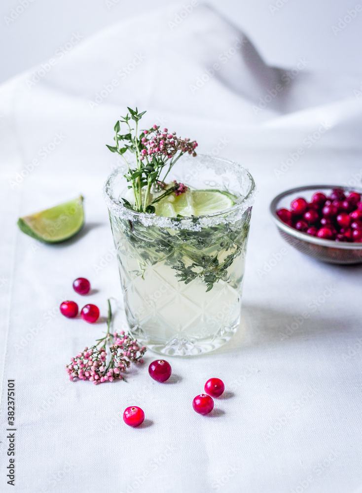 natural cocktail with berry and cut lime on stone desk background