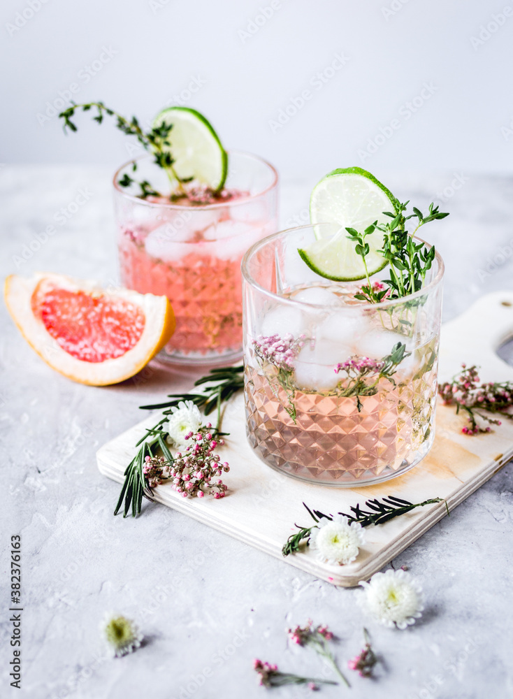 summer homemade juice with lime and blossom on stone table background