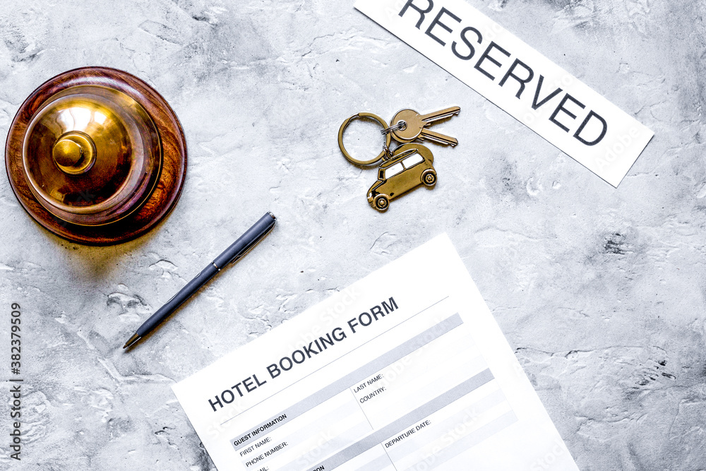 hotel reception desk with booking form and ring stone background top view