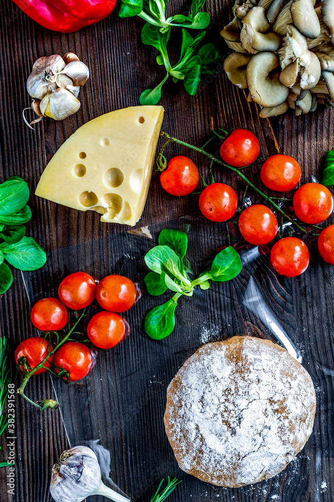 vegetables and cheese for cooking pizza on wooden table background top view